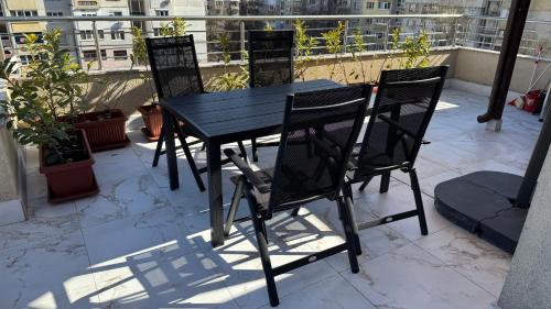 a black table and chairs on a balcony at Apartment near Vitosha mountain, self check-in, with underground parking in Sofia