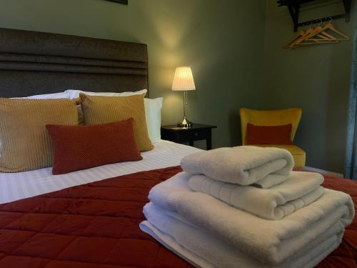 a bedroom with a bed with towels on it at Creag Mhor Lodge in Onich