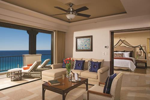 a living room with a bedroom and a bed and a table at Secrets Puerto Los Cabos Golf & Spa18+ in San José del Cabo