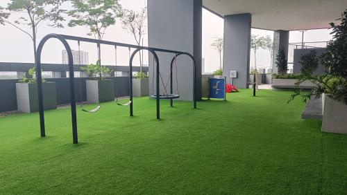 an empty gym with swings on the grass at Homestay Service Apartment Meta City Seri Kembangan-Putrajaya-Puchong-KL in Seri Kembangan