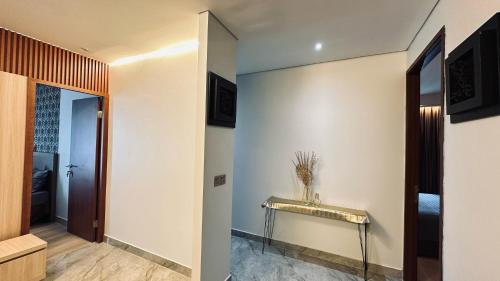 a hallway with a console table on the wall at The H Tower Rasuna Suites Kuningan Jakarta By Villaloka in Jakarta