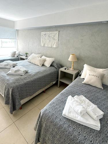a bedroom with two beds with towels on them at Hotel Termal Rio Hondo in Termas de Río Hondo