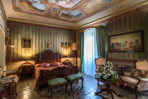 a bedroom with a bed and a couch and a table at Le Porte del Tempo in Mazara del Vallo