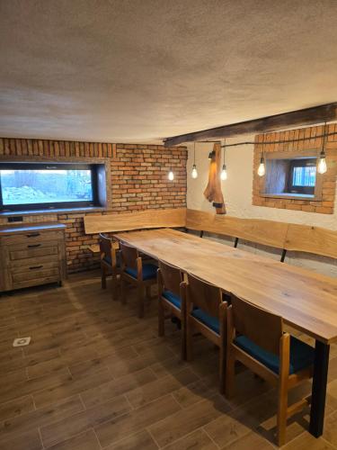 a large room with a long wooden table and chairs at Luxusný apartmán Karolína in Telgárt