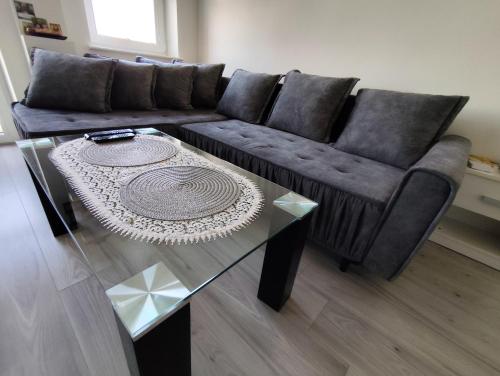 a living room with a couch and a glass table at Sweet Apartament 6 osobowy in Płock