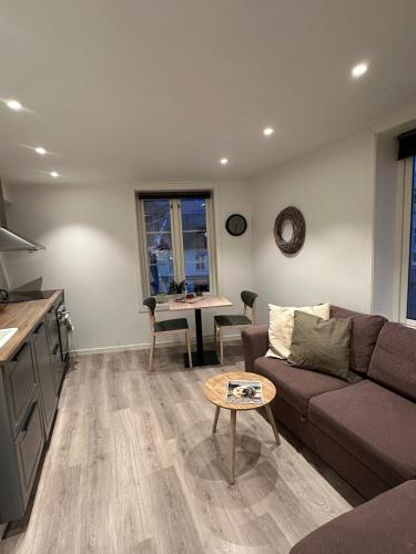 a living room with a couch and a table at Central apartment in Kragerø in Kragerø