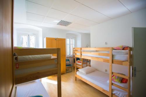a room with two bunk beds in a room at Hostel Kosy in Rijeka