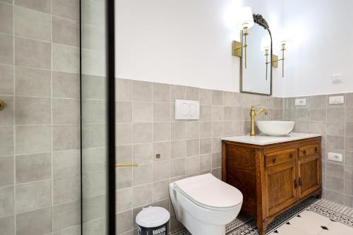 a bathroom with a toilet and a sink and a shower at SanPietro Vacation Apartments in Durrës