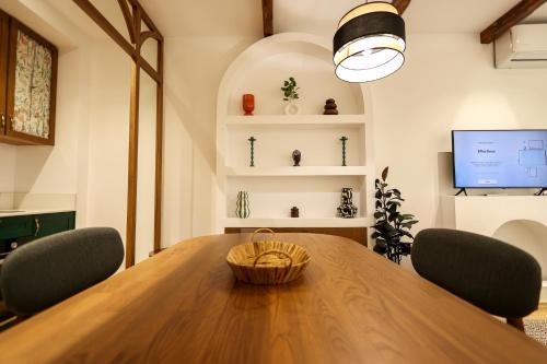 a dining room with a wooden table and chairs at SanPietro Vacation Apartments in Durrës