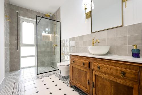 a bathroom with a sink and a toilet and a shower at SanPietro Vacation Apartments in Durrës