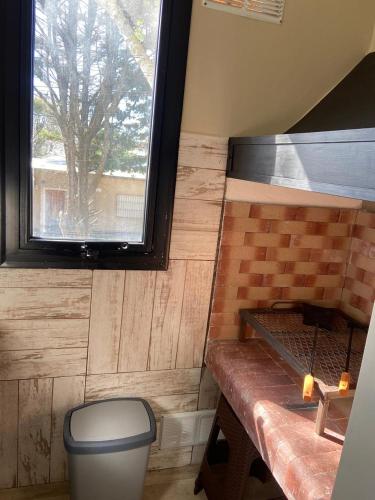 a small bathroom with a toilet and a window at Complejo Médanos II in San Bernardo