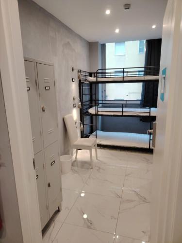 a room with two bunk beds and a desk and a chair at Lion University & Youth Hostel Milano in Milan