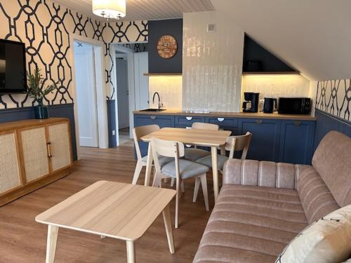 a living room with a couch and a table at Apartamenty Dolina Wisełka in Wisełka