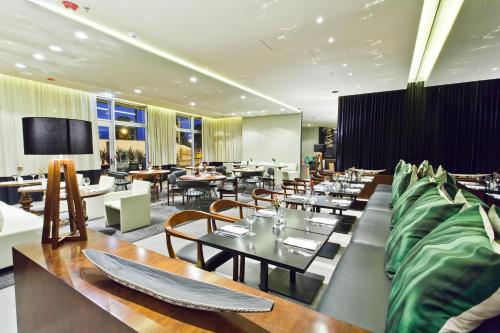 a dining room with tables and chairs and tablesearcher at Movich Buro 26 in Bogotá