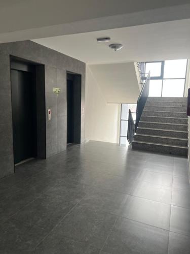 an empty room with stairs in a building at Liam Apartament in Prizren