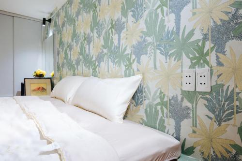 a bedroom with a bed with a floral wallpaper at Old Quarter 6 Senses 3Br Hoan Kiem in Hanoi