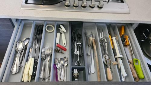 a drawer filled with different types of utensils at Villa gli Ulivi - Bariloche Lake & Mountain View in Perledo