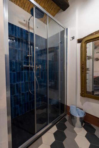 a bathroom with a glass shower with a tiled floor at Le Cementine in Sorgono
