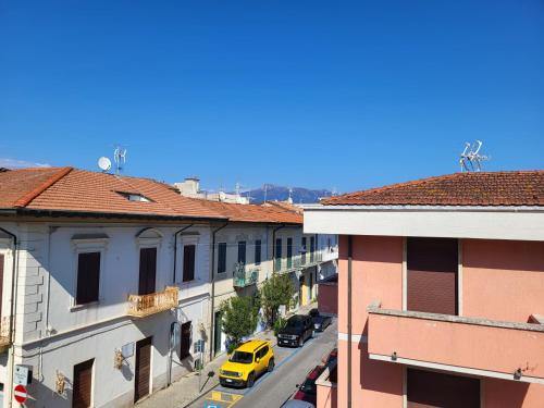a yellow car driving down a city street with buildings at A due passi dal mare Lovely Apartment Viareggio in Viareggio