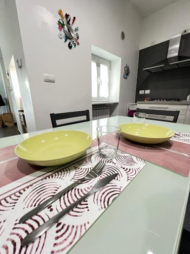 two yellow plates sitting on a table in a kitchen at A Ka-sa in Molfetta