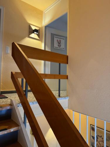 a wooden staircase in a house with a window at GraueMaus in Asendorf