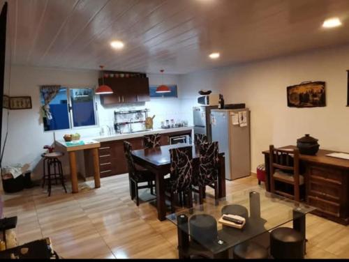 a kitchen with a table and a kitchen with a refrigerator at Maravillosa casa de mar in San Luis