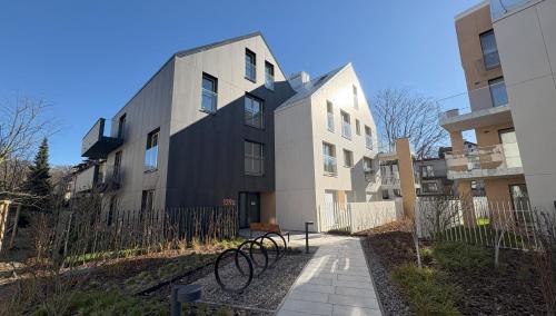 a building with a bike parked in front of it at Baltic Apartment White Diuna Supernovi in Gdynia