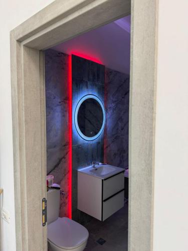 a bathroom with a white sink and a mirror at Dady's Apartament in Roşu