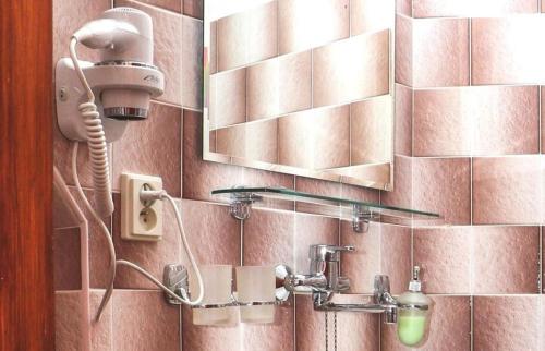 a bathroom with a blow dryer on a wall at Kajovska 64 in Český Krumlov