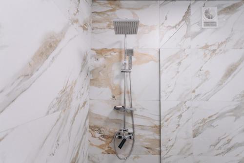 a shower with a cat on the wall in a bathroom at Apart Prokof'yeva in Sumy