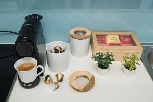 a counter with cups and a coffee maker and a box at Beachfront ZEN sea view apartment in Itea