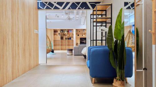 a room with a blue chair and a living room at Hotel Mapp in Taichung