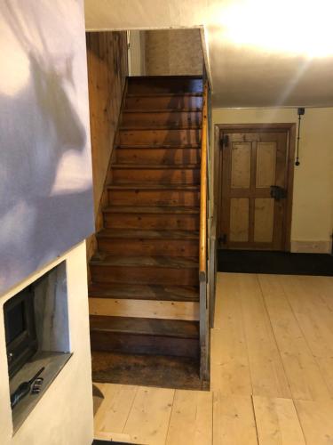 a stairwell in a building with a wooden floor at Floras Haus Hostel in Schattwald