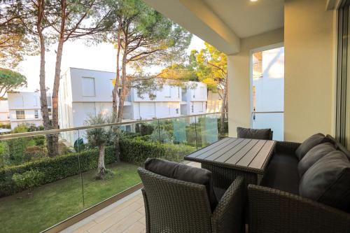 a patio with a table and chairs and a balcony at SanPietro Vacation Apartments in Durrës