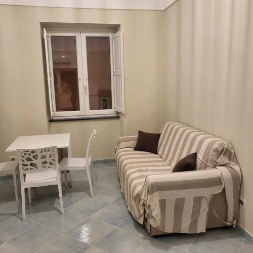 a living room with a couch and a table at Palazzo Palumbo in Procida