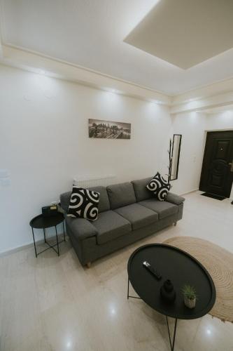 a living room with a couch and a table at Panorama Apartment in Kozani