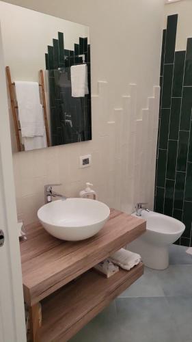 a bathroom with a white sink and a mirror at Palazzo Palumbo in Procida