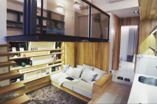 a living room with a white couch and a chandelier at BV Taipei XinYi D in Taipei