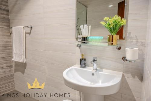 a bathroom with a sink and a mirror at Dunya tower suite 2 in Dubai