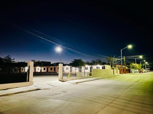 an empty parking lot at night with street lights at Posada Los Olivos in Loreto