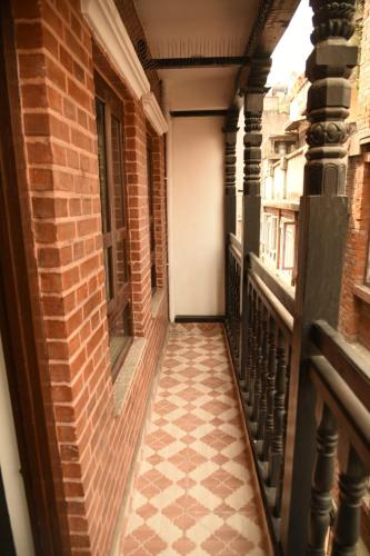 an empty hallway of a building with a tile floor at Jhochhen Rooms in Kathmandu