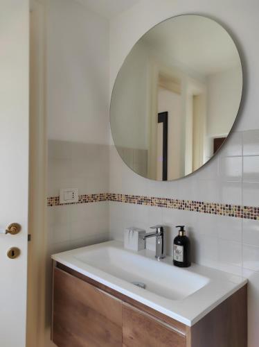 a bathroom with a sink and a mirror at Noù la tua casa in Puglia in Alberobello