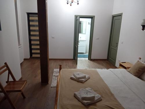 a room with a bed with two towels on it at Cabana Gura Voronețului in Gura Humorului