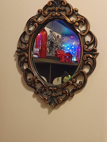 an ornate mirror hanging on a wall at CHRYSSA - ΧΡΥΣΑ in Patra