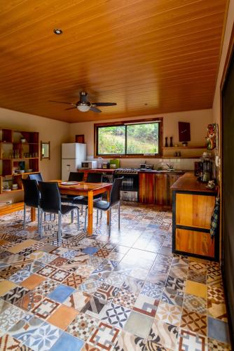 a kitchen with a table and chairs in a room at Corcovado Accommodations-pool-best views-nature in Puerto Jiménez