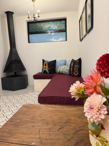 a bedroom with a bed and flowers in a room at French Kisses in Greyton