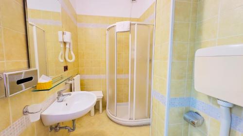 a bathroom with a sink and a shower at Residence & Suites in Bellaria-Igea Marina