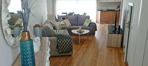 a living room with a couch and a table at Home Away in Vila Nova de Milfontes