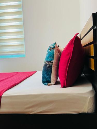 a bed with two pillows sitting on top of it at AquaTerra Comfy stay Varkala beach in Varkala