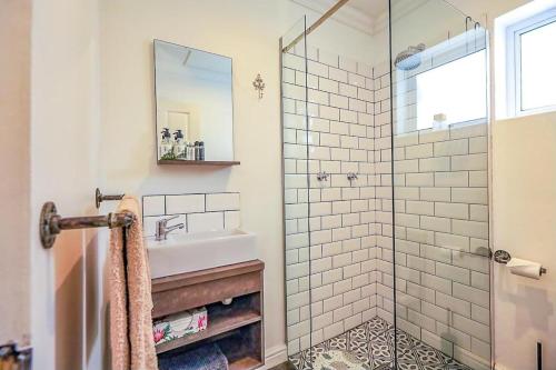 a bathroom with a sink and a shower at The Hedge Cottage in Riebeek-Kasteel